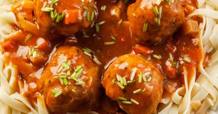 Meatballs in a slow cooker with egg noodles and savory sauce